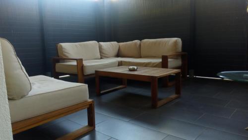 a living room with a couch and a coffee table at 3 Doppelbett Business Apartment am Bodensee in Arbon