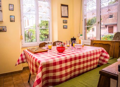 a table with a red and white checkered table cloth at "Chez Michele & Christian " in Barr