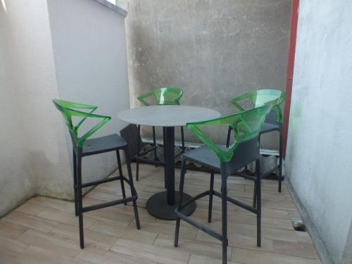 a table and four chairs in a room at Residence Miranto in Châteauroux