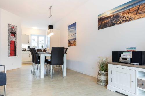 a dining room and kitchen with a table and chairs at Alte Waescherei _9462_ in List