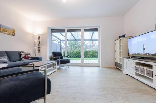 a living room with a large flat screen tv at Alte Waescherei _9461_ in List