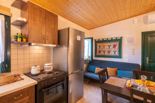 a kitchen with a stainless steel refrigerator and a table at Liodentro - Olea in Plataria