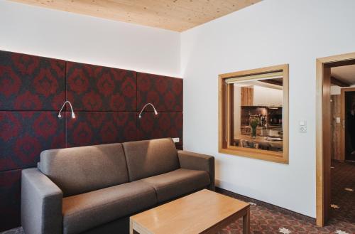 a living room with a couch and a table at Hotel Adler in Warth am Arlberg