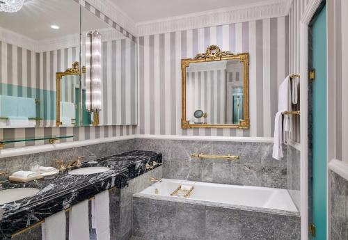 a bathroom with two sinks and a large tub at 5th & 55th Residence Club in New York