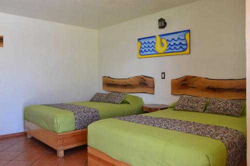 A bed or beds in a room at Hotel Tlatoani