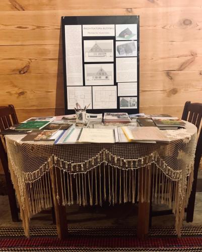 a table with a table cloth and papers on it at Dom Podcieniowy na Żuławach Wiślanych in Nowy Dwór Gdański