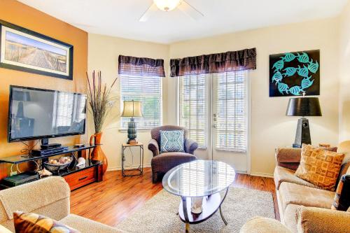 a living room filled with furniture and a tv at Beach Club Condos in Padre Island