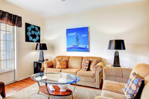 a living room with a couch and a table at Beach Club Condos in Padre Island