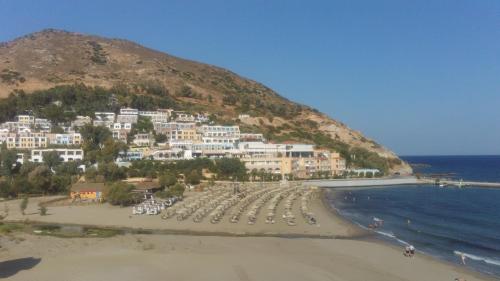 a view of a beach with white buildings and the ocean at Orange Fodele in Fodele