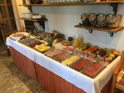 a buffet with many different types of food on a table at Hotel Colonial de Santillana in Santillana del Mar