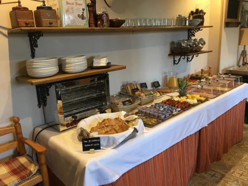 a buffet line with food on top of it at Hotel Colonial de Santillana in Santillana del Mar