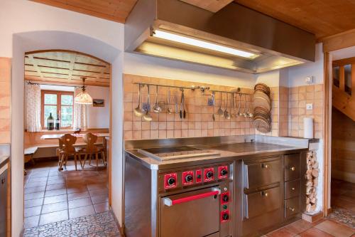 a large kitchen with a stove and a dining room at Golmerhaus in Schruns-Tschagguns