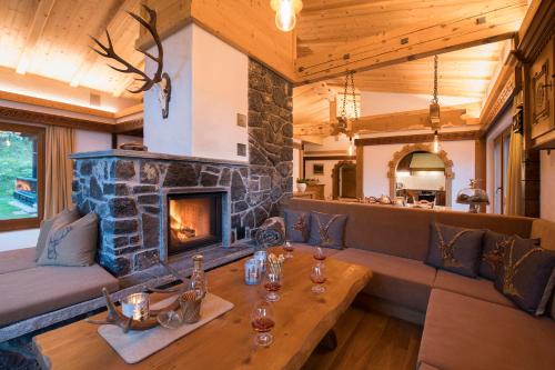a living room with a stone fireplace in a house at Chalet Waldhaus Rappakopf in Tschagguns