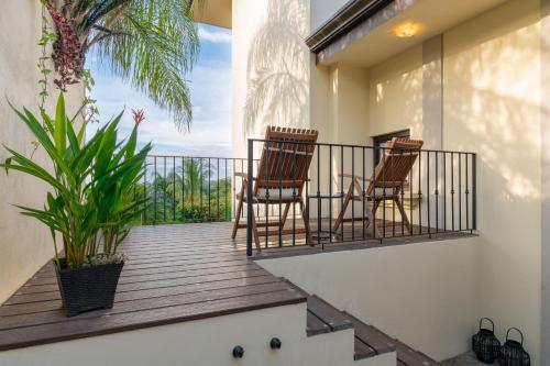 two chairs sitting on a balcony with a view at Villa Buena Onda All Inclusive in Coco