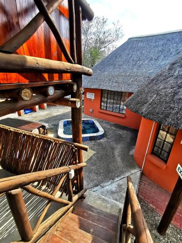 an outside view of a building with a bench and a pool at John and Noleen's place in Marloth Park