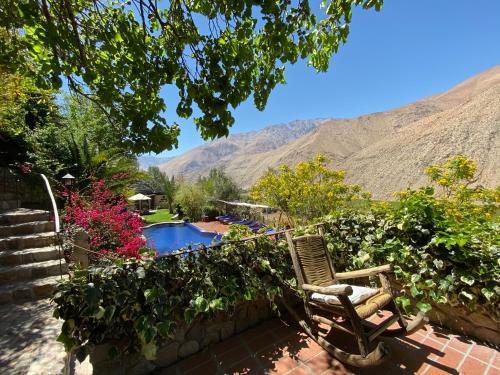 a yard with a chair and a swimming pool at Cabañas Caballieri in Pisco Elqui