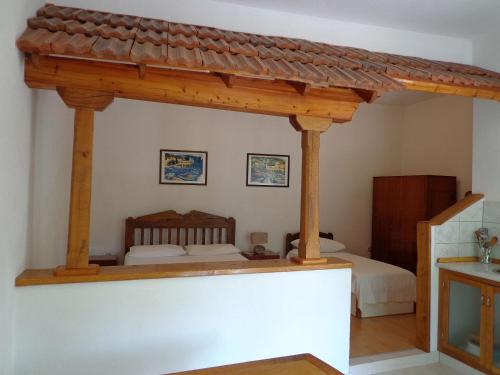a bedroom with a bed with a wooden roof at Apartments Brane - 150m from sea in Bol