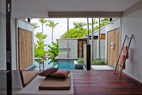a room with a pool and a house at Sareeraya Villas & Suites - SHA Extra Plus in Chaweng
