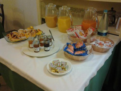 a table topped with plates of food and drinks at Agriturismo Antico Muro in Sassoferrato