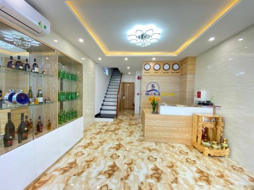 a wine tasting room with wine bottles on the wall at Blue-S Hotel & Apartment in Da Nang