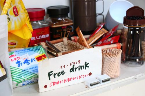 a free drink sign sitting on top of a drawer at Gokase Campsite Camping and Guesthouse in Gokase