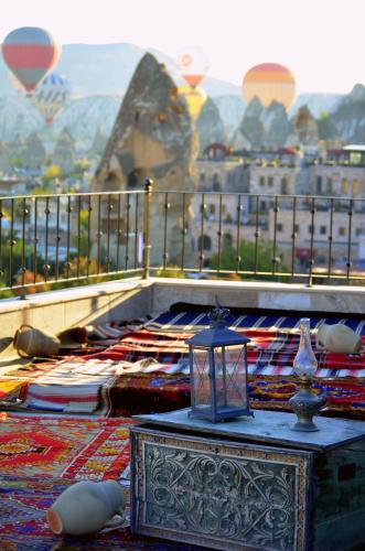 a balcony with a table with a view of a city at Zara Cave Hotel in Goreme