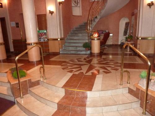 a large stairway leading up to a lobby area at Wellness Hotel Jean De Carro in Karlovy Vary