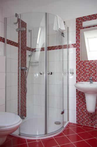 a bathroom with a shower and a sink at Pension Kiwi in Mikulov