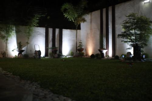 a building with trees in the yard at night at Fully Furnished Villa Near Clark in Mabiga, Mabalacat City in Mabalacat