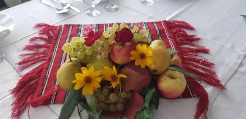 a bunch of fruits and flowers on a table at Mai Danube in Eşelniţa