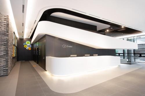 a lobby with a white reception desk in a building at Orakai Daehakro Hotel, BW Signature Collection in Seoul