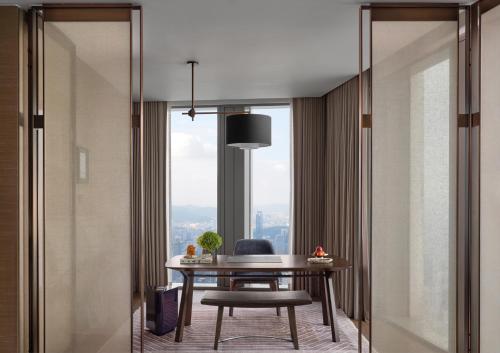 a dining room with a table and a window at Rosewood Guangzhou, enjoy free shuttle bus service between the hotel and the Canton Fair Complex during the Canton Fair in Guangzhou