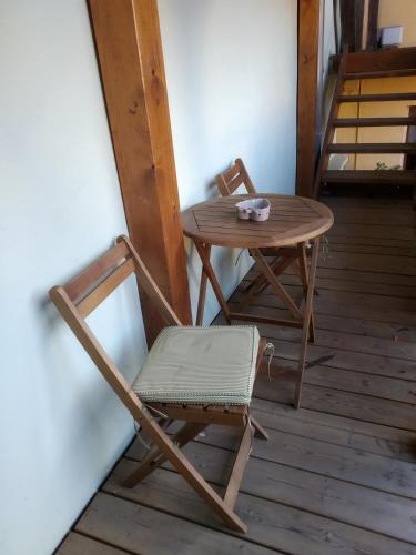 a wooden table and a chair and a table and a table at Chez Frédéric et Alexandre in Bennwihr