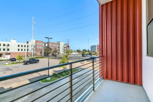 a balcony with a red wall and a view of a street at Modern 4BR Villas with Amenities in New Orleans