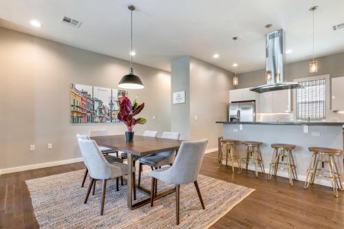 a dining room and kitchen with a table and chairs at Modern 4BR Villas with Amenities in New Orleans