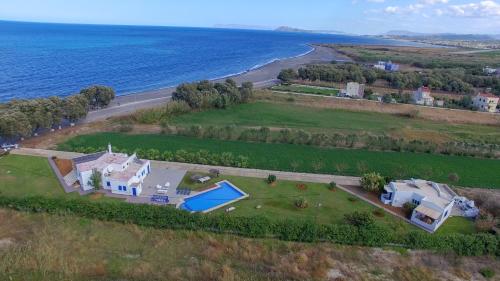 an aerial view of a house and the ocean at Oasea in Tavronitis