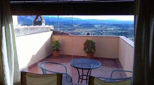 a balcony with a table and chairs and a view at El Racó de les Grases in Horta de San Joan