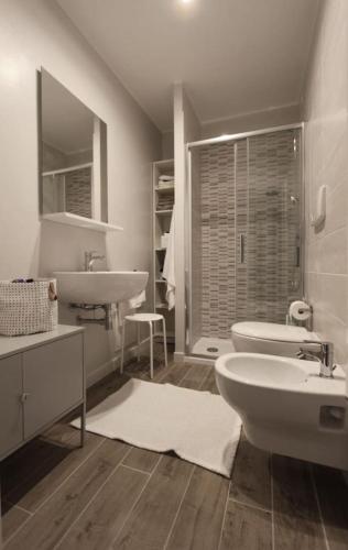 a white bathroom with a sink and a toilet at casa Ginepro in Terralba