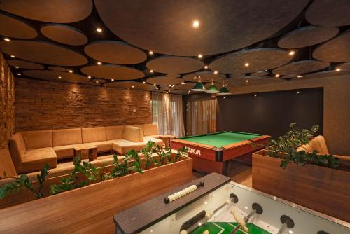 a living room with a pool table and ping pong ball at Hotel Termál in Vyhne