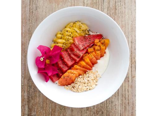 a bowl of food with meat and vegetables and rice at Myamo Beach Lodge in Jereweh