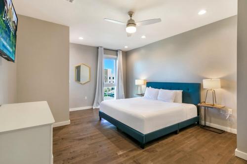 a bedroom with a large bed with a blue headboard at Fully-Furnished Townhouse with Luxury Amenities in New Orleans