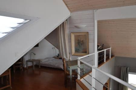 a room with a staircase and a room with a bed at le montanet in Thollon