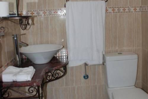 a bathroom with a sink and a toilet and a sink at Hotel Safa in Sidi Ifni