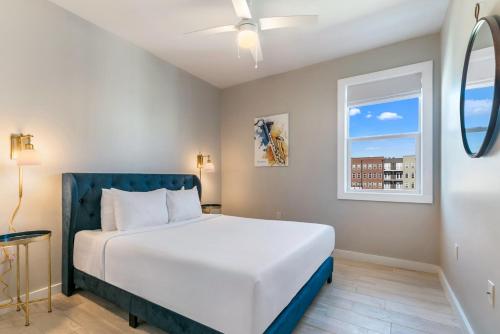 a bedroom with a white bed and a window at Mid City Fully Furnished Townhouse in New Orleans