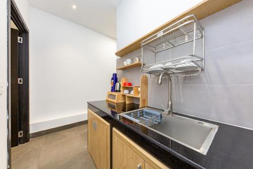 a kitchen with a sink and a counter top at QA Hotel Dalat - City Centre in Da Lat