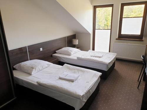 Łóżko lub łóżka w pokoju w obiekcie Perła Podhala