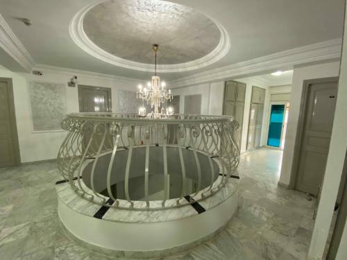 a large room with a chandelier in a building at Hôtel le calife in Tunis