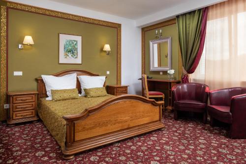a hotel room with a bed and a desk at Grand Hotel in Braşov