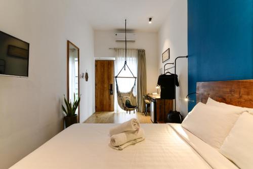 a bedroom with a bed with a towel on it at Leaf Signature Hotel - Lá Group in Ho Chi Minh City