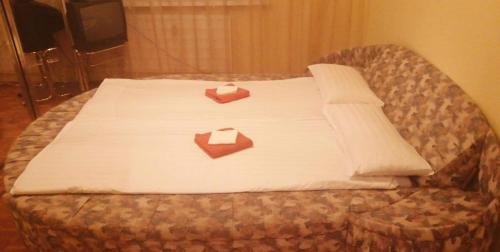 Una cama con dos cajas encima. en Byt vo Fiľakove, en Fiľakovo